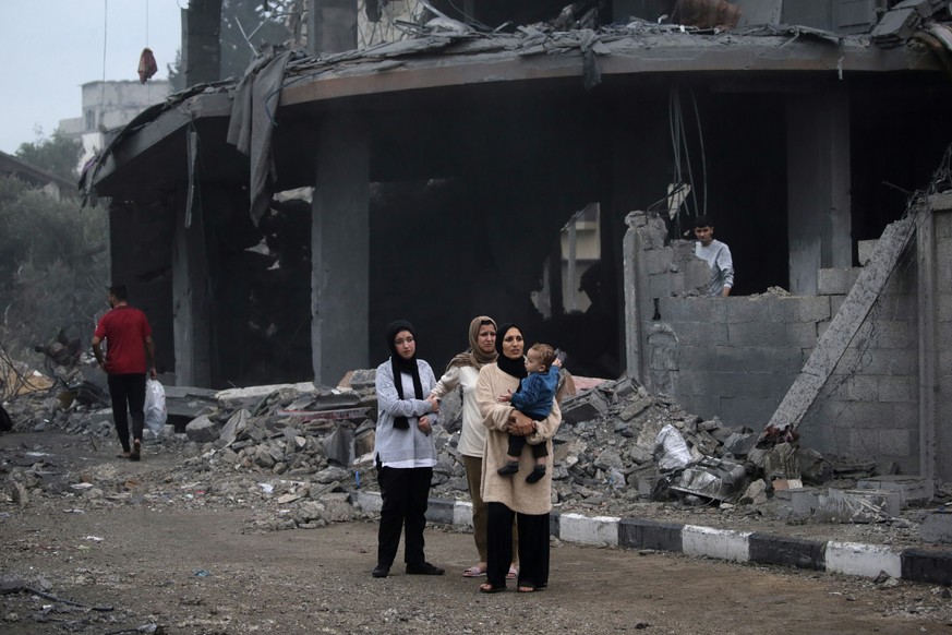 epa11012062 Palestinians make their way through the rubble after Israeli airstrikes on Deir Al Balah in the southern Gaza Strip, December 5, 2023. Israeli forces resume military attacks on Gaza...
