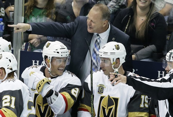 Vegas Golden Knights coach Gerard Gallant points from the bench, behind center Jonathan Marchessault (81) and right wing Reilly Smith (19) during the third period of an NHL hockey game against the Dal ...