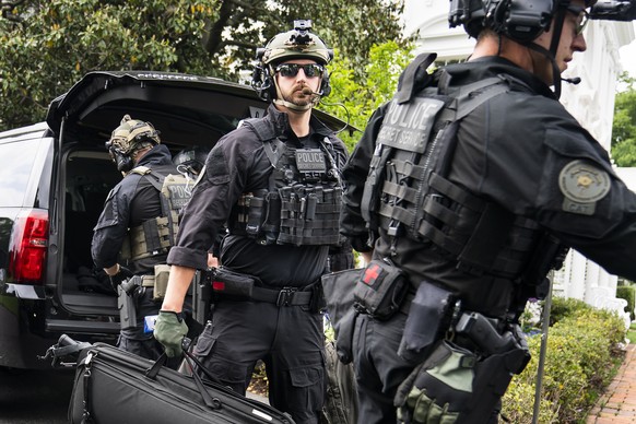 epa07547487 Secret Service agents unload their gear after ferrying US President Donald J. Trump from the Trump National Golf Course in Sterling, Virginia back to the White House in Washington, DC, USA ...