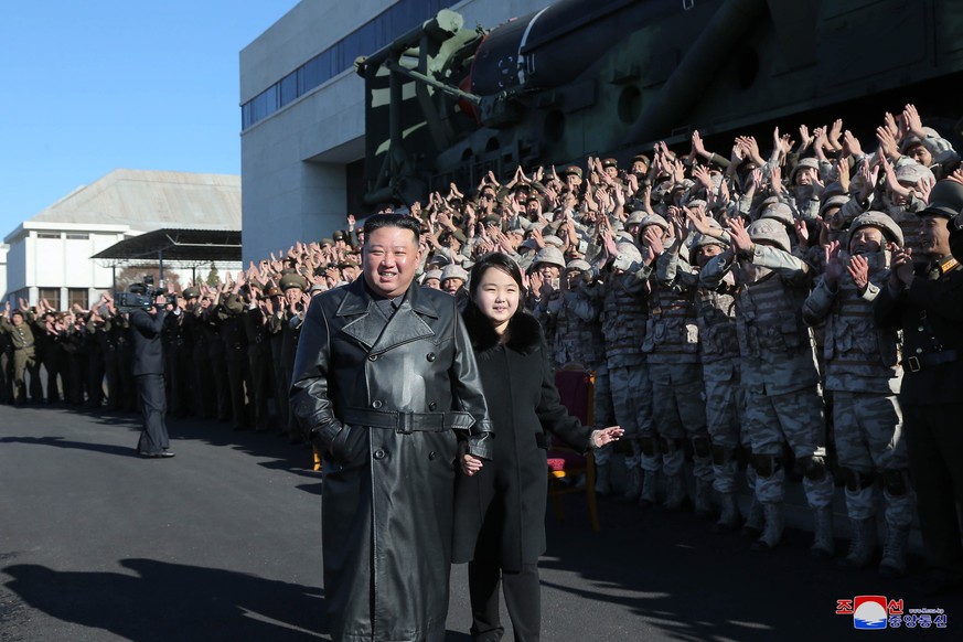 epa10331640 An undated photo released by the official North Korean Central News Agency (KCNA) on 27 November 2022 shows North Korean leader Kim Jong-un (C-L) walking with his daughter, presumed to be ...