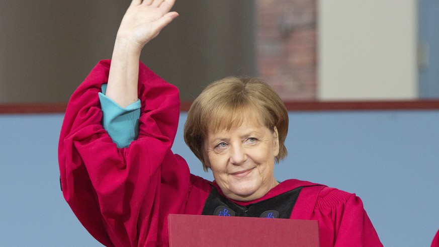 epa07612922 German Chancellor Angela Merkel acknowledges the audience as she is honored with an Honorary Doctorate of Laws Degree during the 368th commencement of Harvard University in Cambridge, Mass ...