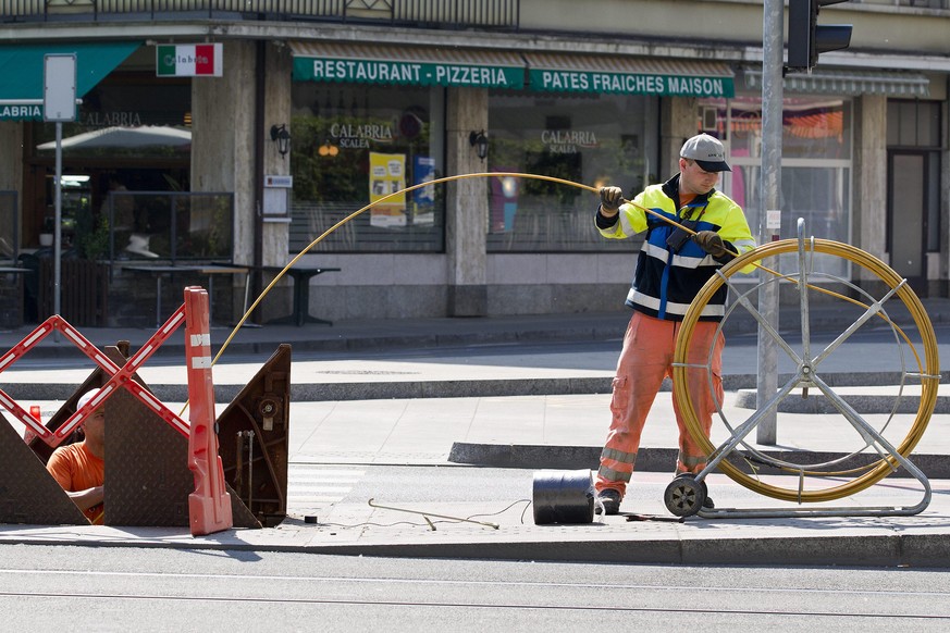 THEMENBILD ZUR ZUSAMMENARBEIT VON SALT UND SUNRISE BEIM AUSBAU DES GLASFASERNETZES --- Workers install fiber optic cables under street of Geneva, in Geneva, Switzerland, Monday, May 2, 2011. (KEYSTONE ...