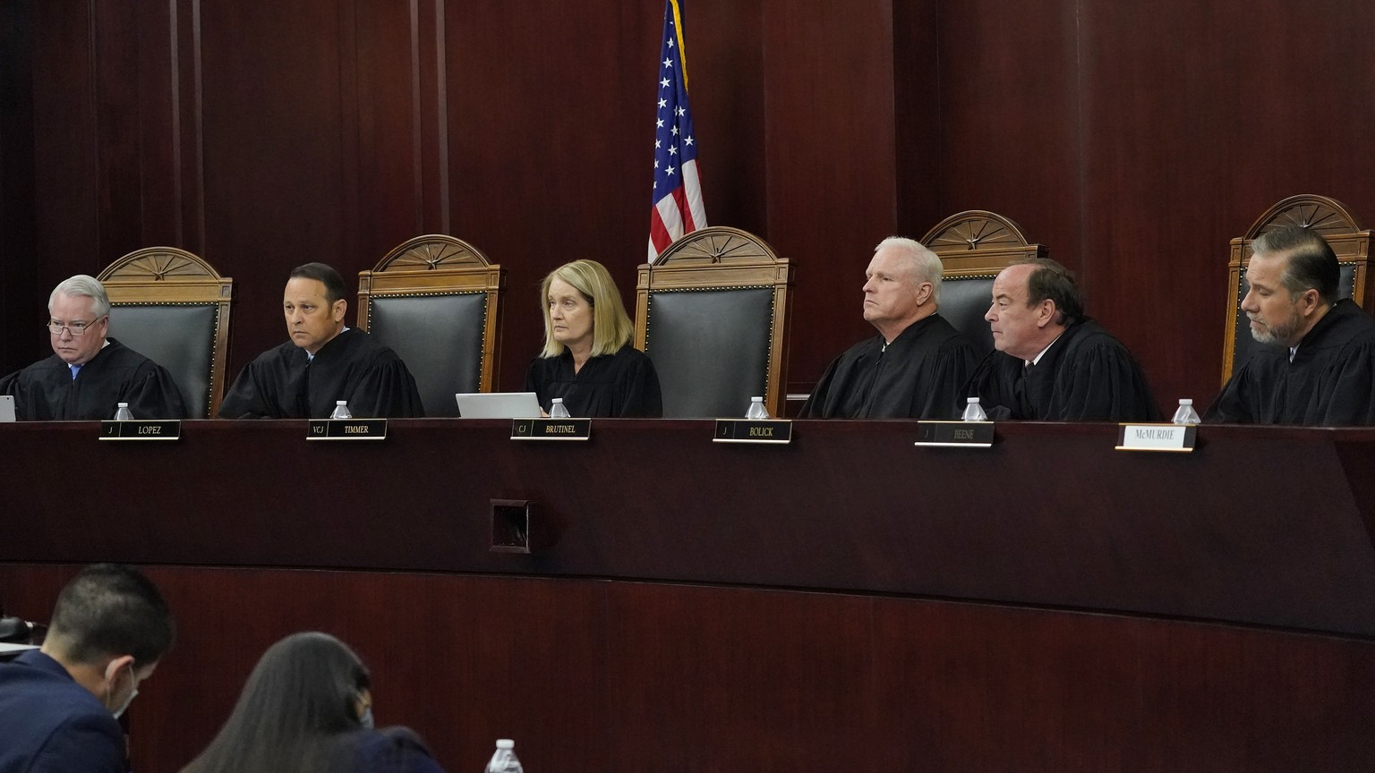 FILE - Arizona Supreme Court Justices from left; William G. Montgomery, John R Lopez IV, Vice Chief Justice Ann A. Scott Timmer, Chief Justice Robert M. Brutinel, Clint Bolick and James Beene listen t ...