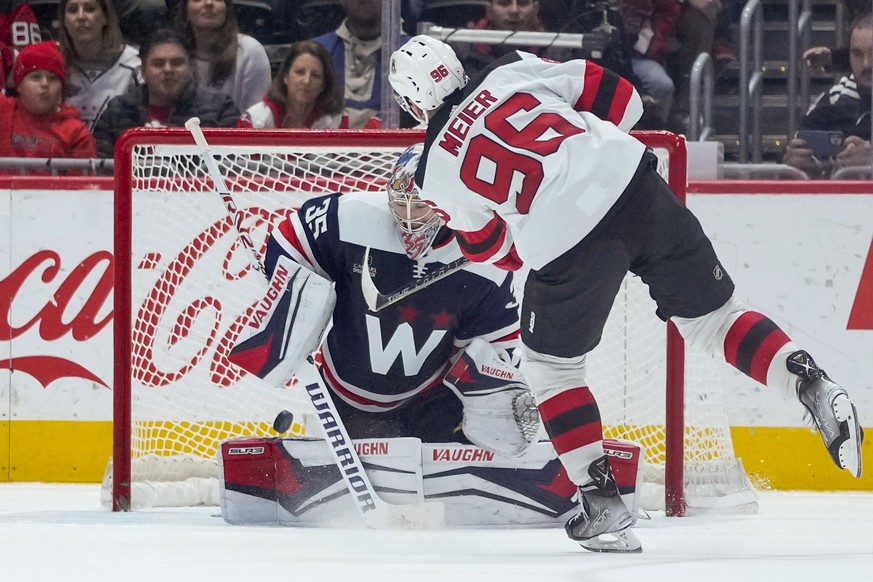 New Jersey Devils right wing Timo Meier (96) scores the game-winning goal past Washington Capitals goaltender Darcy Kuemper (35) during a shootout of an NHL hockey game, Thursday, March 9, 2023, in Wa ...