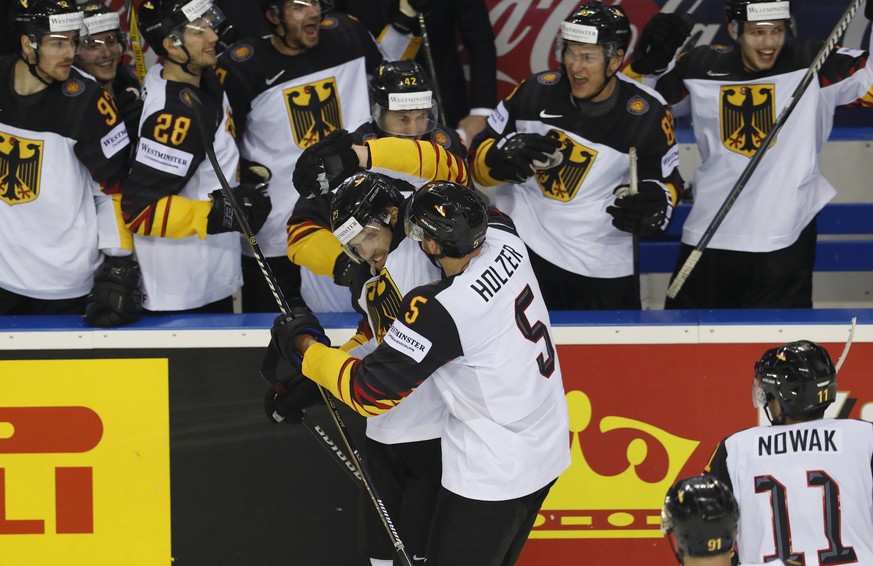 Germany&#039;s Leon Draisaitl, center left, celebrates with teammates after scoring his sides third goal during the Ice Hockey World Championships group A match between the United States and Great Bri ...