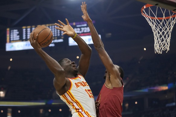 Atlanta Hawks center Clint Capela (15) shoots as Cleveland Cavaliers forward Evan Mobley, right, defends in the first half of an In-Season Tournament NBA basketball game, Tuesday, Nov. 28, 2023, in Cl ...
