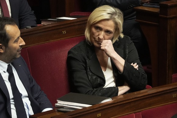 French far-right leader Marine Le Pen listens as French Interior Minister Gerald Darmanin delivers a speech at the French National Assembly in Paris, Monday, dec. 11, 2023. A divisive migration bill t ...