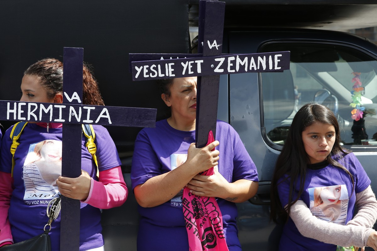 Women hold crosses in memory of other women who have been murdered or disappeared as they demand justice for their loved ones one day after the Day of the Dead holiday in Mexico City, Sunday, Nov. 3,  ...