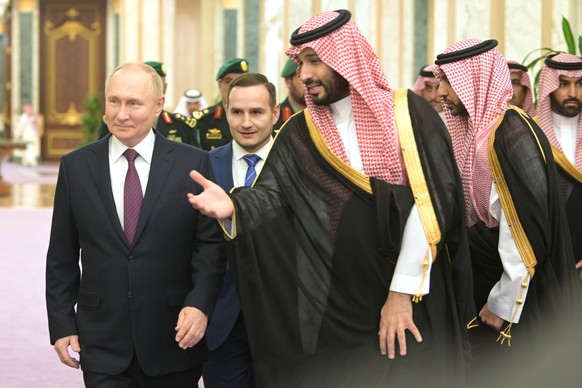 epa11014305 Saudi Arabian Crown Prince Mohammed bin Salman Al Saud (C) welcomes Russian President Vladimir Putin (L), during their meeting at Al Yamamah Palace in Riyadh, Saudi Arabia, 06 December 202 ...
