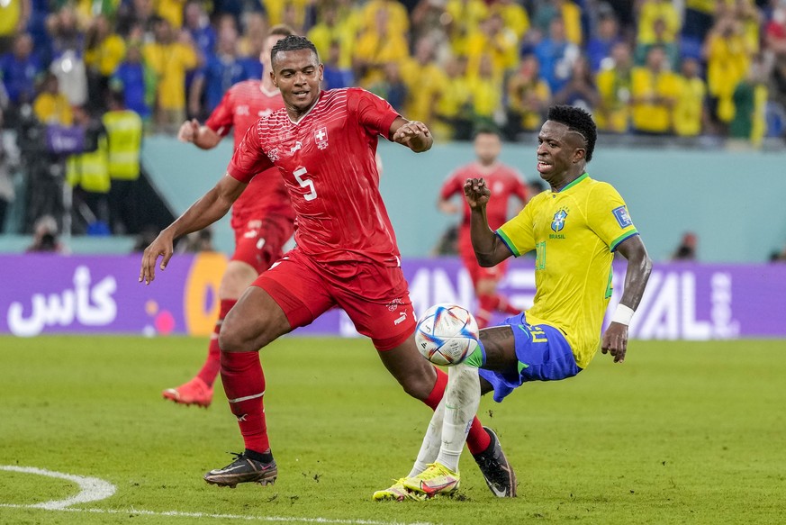 Brazil's Vinicius Junior, right, fights for the ball with Switzerland's Manuel Akanji during the World Cup group G soccer match between Brazil and Switzerland, at the Stadium 974 in Doha, Qatar, Monda ...