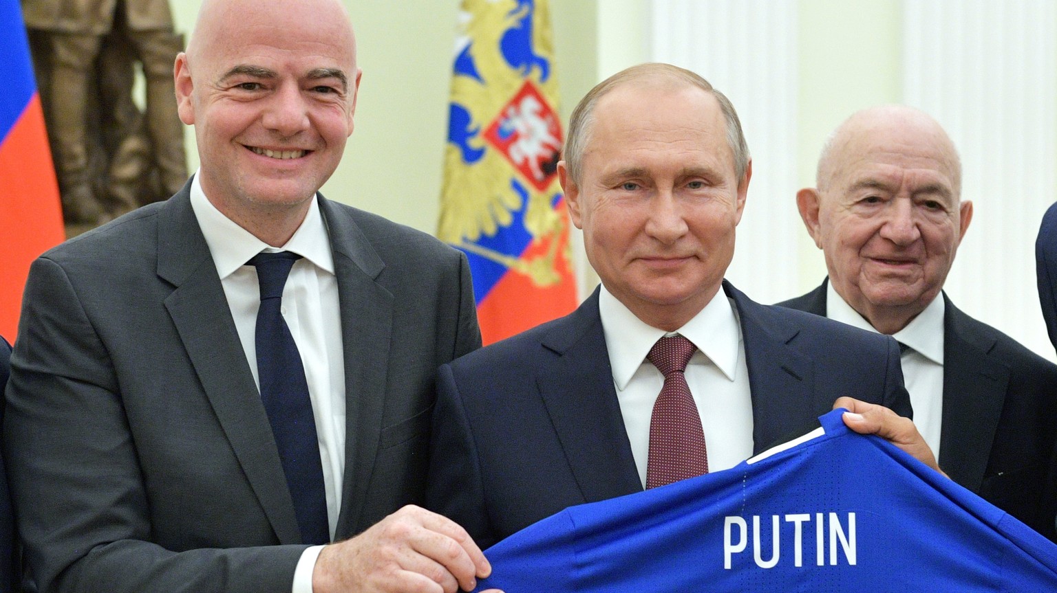 Russian President Vladimir Putin, center, poses for a photo with world soccer legends, former German soccer player Lothar Matthaus, left, FIFA President Gianni Infantino, second left, former Mexican s ...