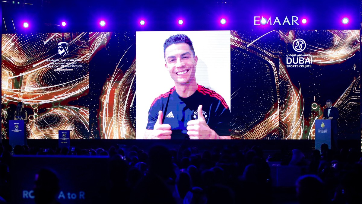epa09658148 Portuguese soccer player Cristiano Ronaldo of Manchester United addresses the audience via a huge video screen regarding his 'Top Goal Scorer of all time' award during the Dubai  ...
