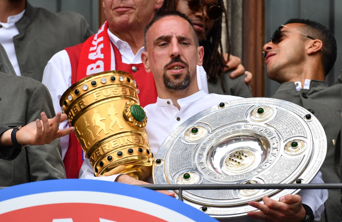 epa07602717 Bayern's Franck Ribery holds the German Bundesliga championship trophy (R) and the the DFB Cup trophy during the celebration of FC Bayern Munich winning German championship and DFB Cu ...