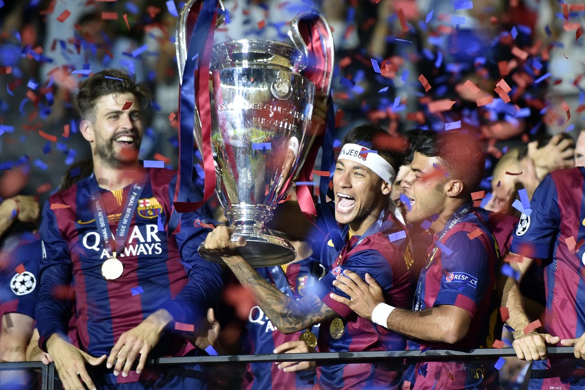 Barcelona's Neymar, center, lifts the trophy after winning 3-1during the Champions League final soccer match between Juventus Turin and FC Barcelona at the Olympic stadium in Berlin Saturday, Jun ...