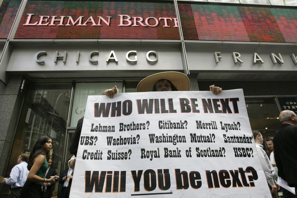 FILE In this Sept. 15, 2008 file photo Robin Radaetz holds a sign in front of the Lehman Brothers headquarters in New York. When Lehman Brothers collapsed, the Greek economy was already in trouble. Fo ...