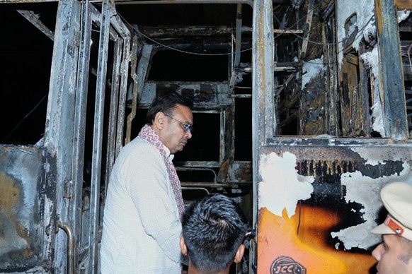 This photograph shared by Indian State Rajasthan Chief Minister&#039;s office shows Chief Minister Bhajan Lal Sharma inspecting a charred passenger bus after a suspected short circuit sparked a deadly ...