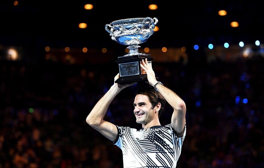 epaselect epa05759083 Roger Federer of Switzerland celebrates with the trophy after winning the Men's Singles final match against Rafael Nadal of Spain at the Australian Open Grand Slam tennis to ...