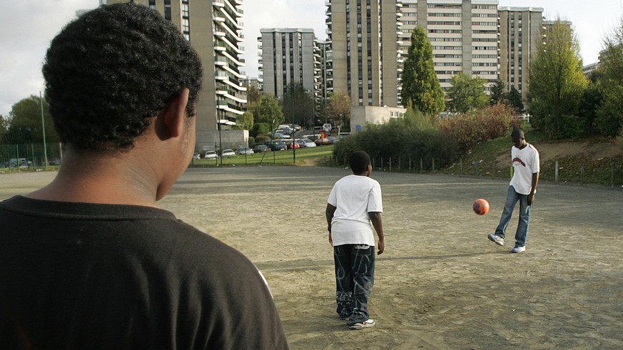 French boys play soccer in a waste ground by their low cost housing complex, Monday, Nov. 7,2005, in Grigny, a suburb south of Paris where, for the first time since the start of the urban violence, po ...