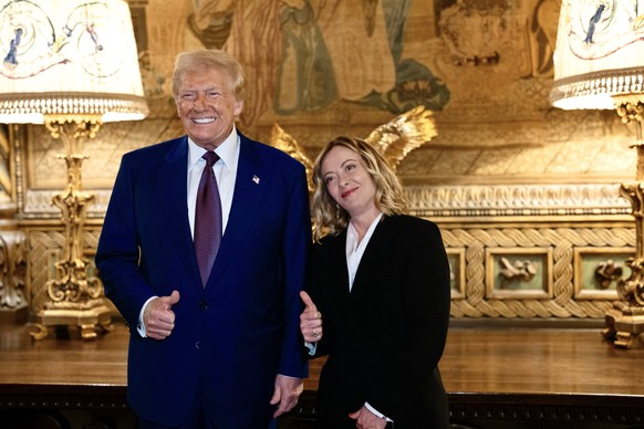 epa11806741 A handout picture made available by the Chigi Palace (Palazzo Chigi) Press Office shows Italian Prime Minister Giorgia Meloni (R) meeting with US President-elect Donald Trump at his reside ...