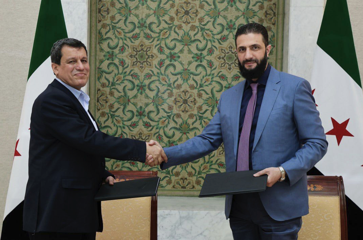 Sur cette photo diffusée par l'agence de presse officielle syrienne SANA, le président par intérim de la Syrie, Ahmad al-Sharaa (à droite), serre la main de Mazloum Abdi, commandant des Forces dé ...