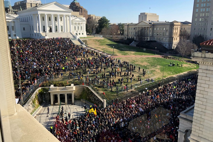 Demonstrators are seen during a pro-gun rally, Monday, Jan. 20, 2020, in Richmond, Va. Thousands of pro-gun supporters are expected at the rally to oppose gun control legislation like universal backgr ...