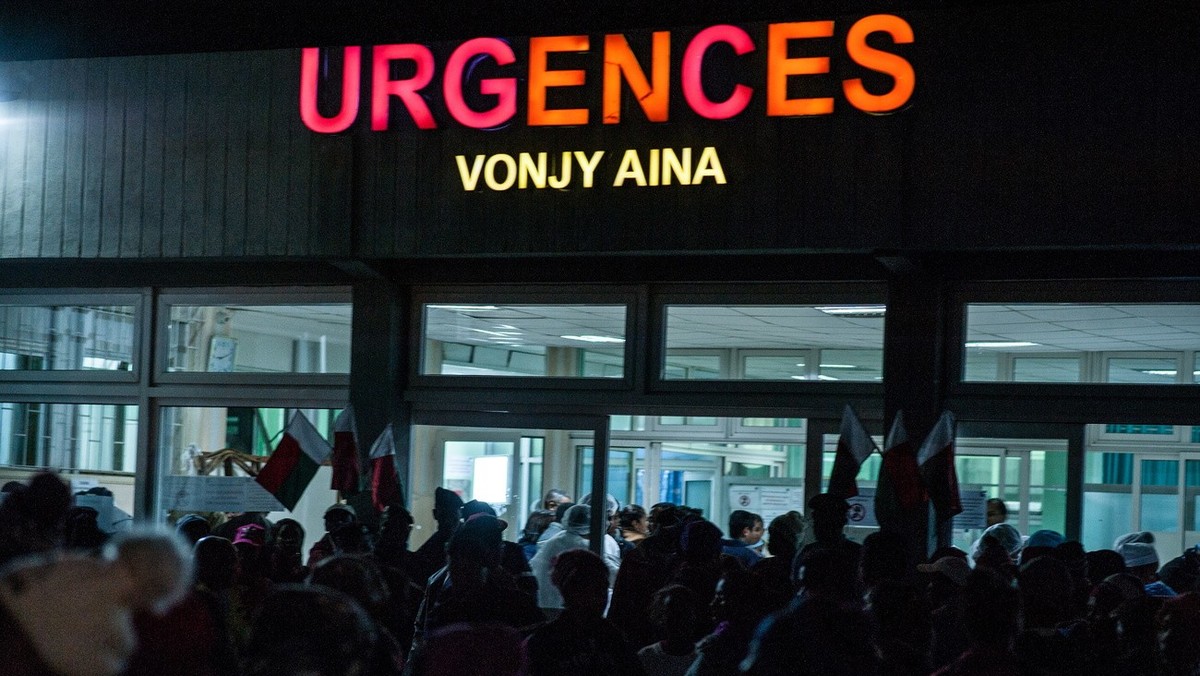 epa07676499 People rush to the entrance of the morgue of a hospital to view the bodies of victims of a crush at a stadium in Antananarivo, Madagascar, 26 June 2019 (issued 27 June 2019). According to  ...