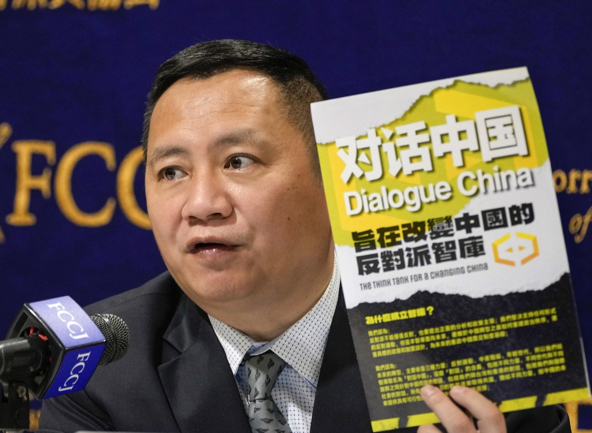 epa10340905 Wang Dan, a prominent former student leader of the Tiananmen democracy movement in 1989, and director of Dialogue China, with his book as he speaks at the Foreign Correspondents' Club ...