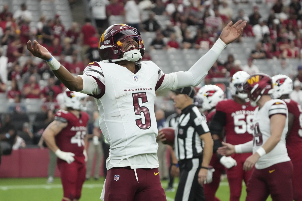 Washington Commanders quarterback Jayden Daniels (5) celebrates a touchdown against the Arizona Cardinals during the second half of an NFL football game, Sunday, Sept. 29, 2024, in Glendale, Ariz. (AP ...