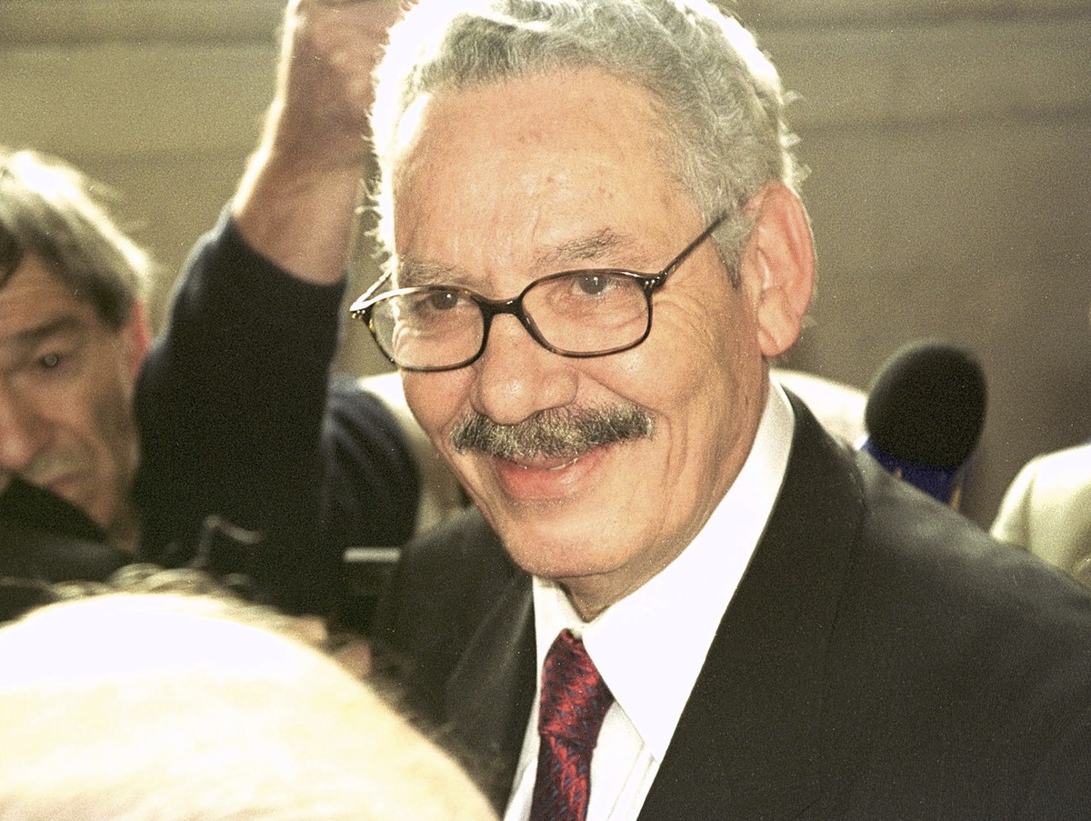 FILE - Former Algerian Defense Minister and retired Gen. Khaled Nezzar smiles as he answers reporters at the Paris courthouse Monday, July 1, 2002. Swiss federal prosecutors said Tuesday they have ind ...