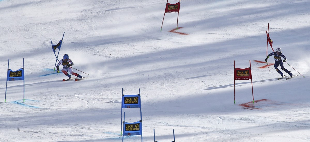 Italy's Marta Bassino, right, and France's Clara Direz compete during an alpine ski, women's World Cup parallel giant slalom in Sestriere, Italy, Sunday, Jan. 19, 2020. (AP Photo/ Marco ...