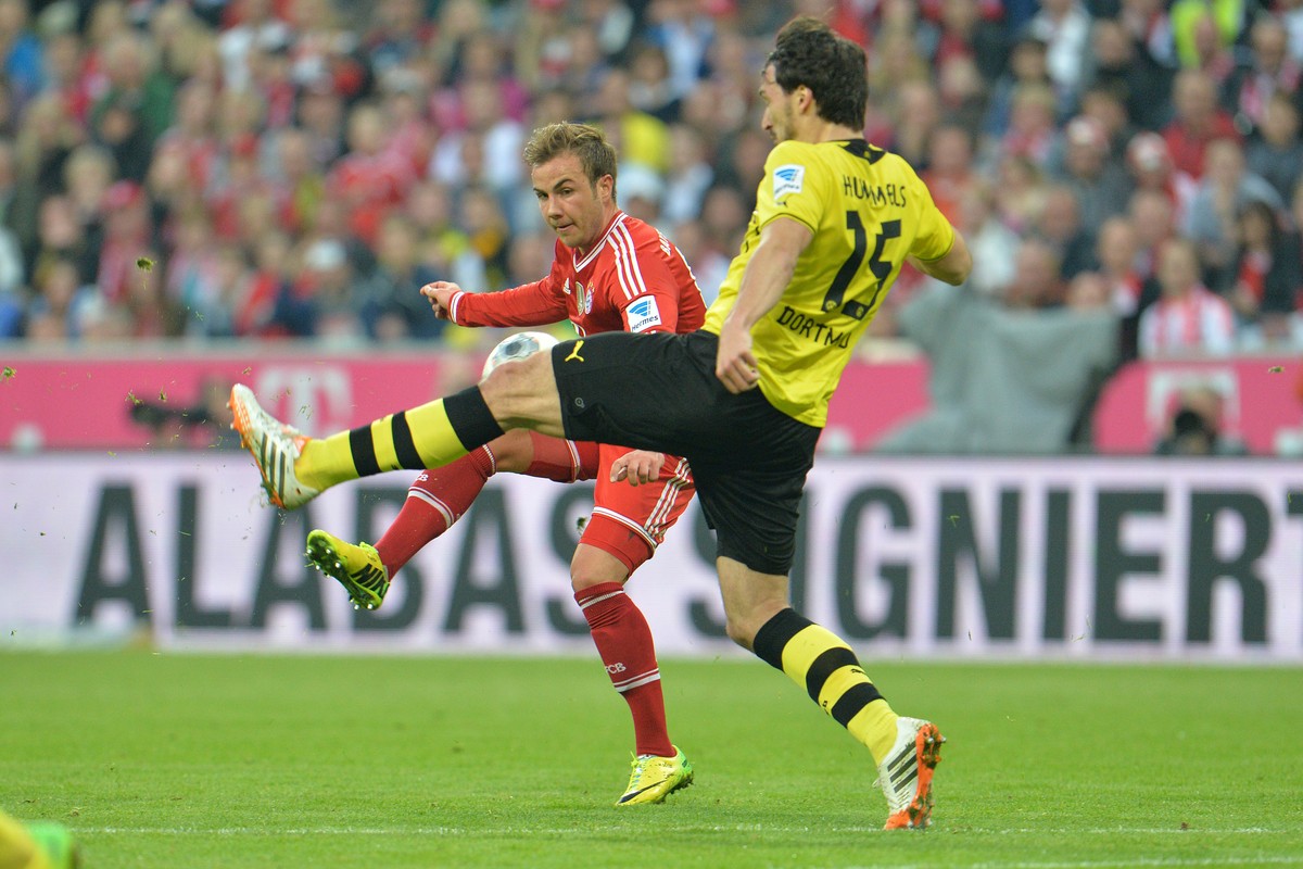 Bayern's Mario Goetze, left, and Dortmund's Mats Hummels challenge for the ball during the soccer match between FC Bayern Munich and Borussia Dortmund in Munich, Germany, on Saturday, April  ...