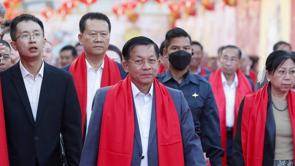 epa10420757 Military Chief of Myanmar Senior General Min Aung Hlaing (C) and Chinese Ambassador to Myanmar Chen Hai (L) arrive at the opening ceremony of the Chinese New Year celebration at the Thuwanna...