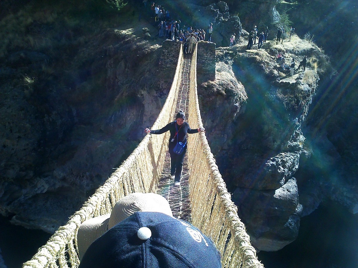epa04245986 An undated handout photo releaded on 08 June 2014 by the Peruvian Culture Ministry shows a woman crossing the suspension bridge Q'eswachaka in Cuzco region, Peru. UNESCO delivered a d ...