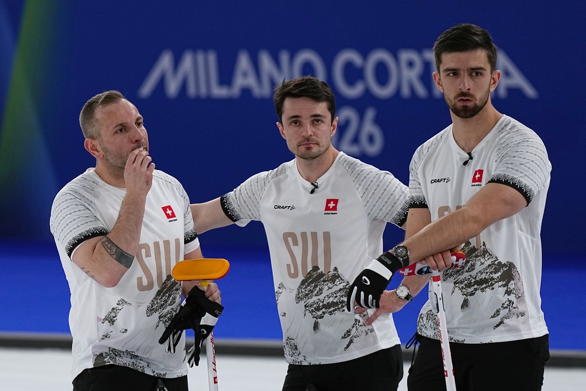 Switzerland's Benoit Schwarz-van Berkel, Sven Michel and Pablo Lachat-Couchepin watch action in a men's curling semifinal match against Britain at the 2026 Winter Olympics, in Cortina d' ...