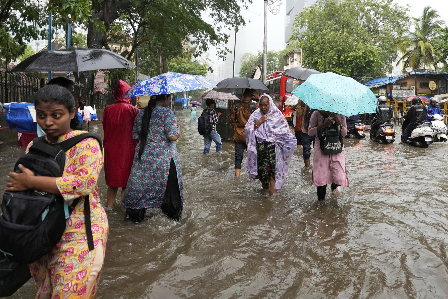 People walk through a water logged street during a heavy rain in Mumbai, India, Monday, May 26, 2025. (AP Photo/Rajanish Kakade)
India Rain