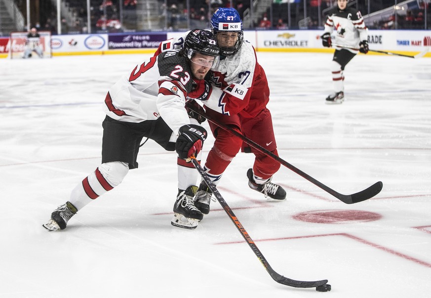 Canada&#039;s Mason McTavish (23) and Czech Republic&#039;s Jiri Kulich (27) battle for the puck during third-period IIHF world junior hockey championship game action in Edmonton, Alberta, Sunday, Dec ...