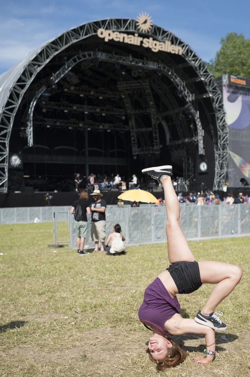 A visitor performs breakdance in front of the main stage during the music festival Openair St. Gallen, on Friday, June 26, 2015, in St. Gallen, Switzerland. (KEYSTONE/Gian Ehrenzeller)