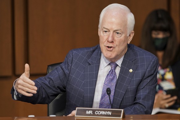 FILE - In this Oct. 15, 2020 file photo, Sen. John Cornyn, R-Texas, speaks with an aide during the confirmation hearing for Supreme Court nominee Amy Coney Barrett, before the Senate Judiciary Committ ...