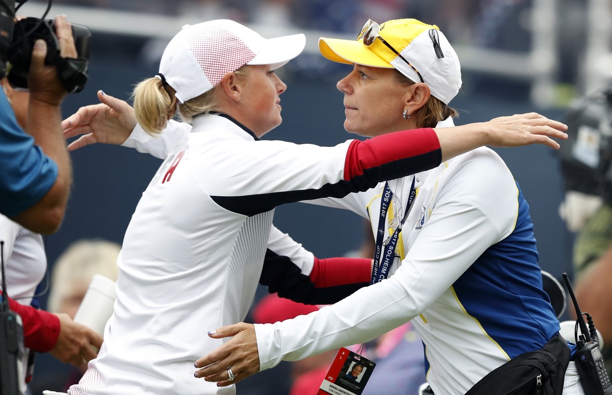 United States' Stacy Lewis, left, gets a hug from Europe captain Annika Sorenstam, of Sweden, before Lewis' foursomes match at the Solheim Cup golf tournament, Friday, Aug. 18, 2017, in West ...
