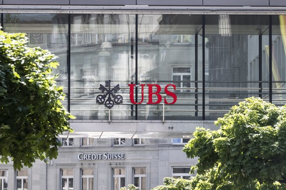 epa10686609 The two logos of the banks UBS and Credit Suisse in Zurich, Switzerland, 12 June 2023. &quot;UBS has completed the legal closing of its acquisition of Credit Suisse&quot; Swiss bank UBS, n ...