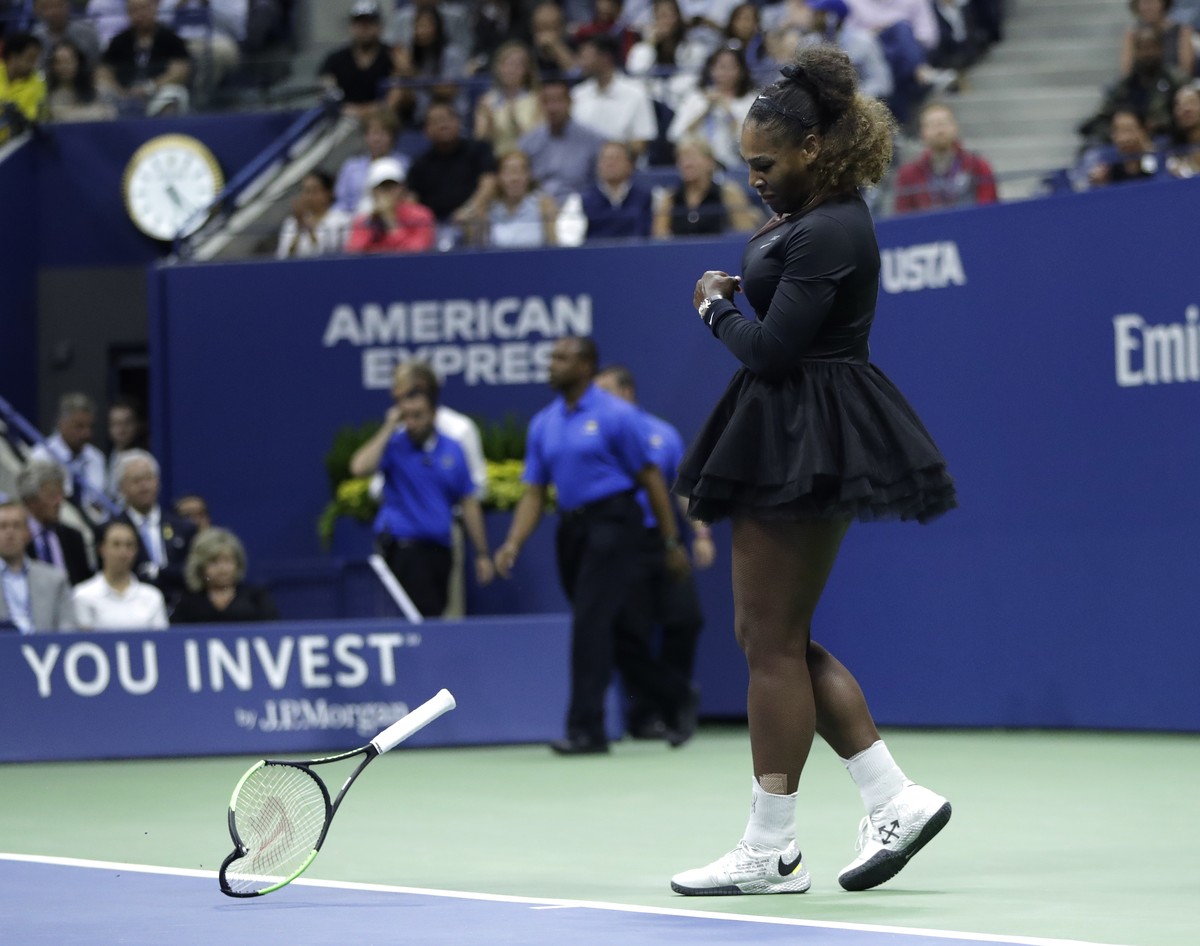 Serena Williams slams her racket on the court during the women's final of the U.S. Open tennis tournament against Naomi Osaka, of Japan, Saturday, Sept. 8, 2018, in New York. (AP Photo/Julio Cort ...