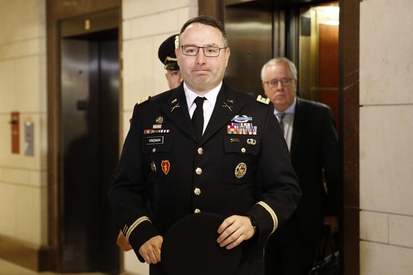 FILE - In this Oct. 29, 2019, file photo, Army Lt. Col. Alexander Vindman, a military officer at the National Security Council, center, arrives on Capitol Hill in Washington. Vindman is set to deliver ...
