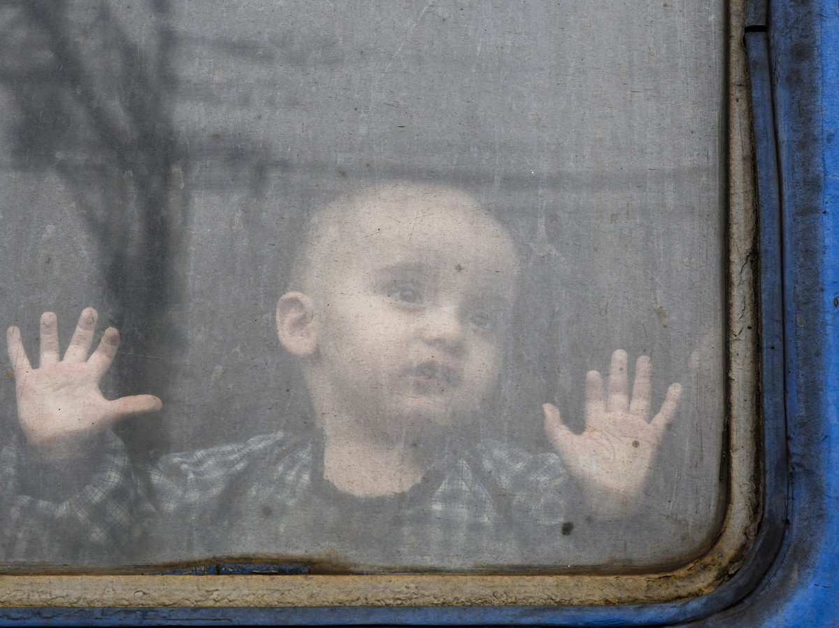 A child watches from from a train carriage waiting to leave Ukraine for western Ukraine at the railway station in Kramatorsk, eastern Ukraine, Sunday, Feb. 27, 2022. The U.N. refugee agency says nearl ...