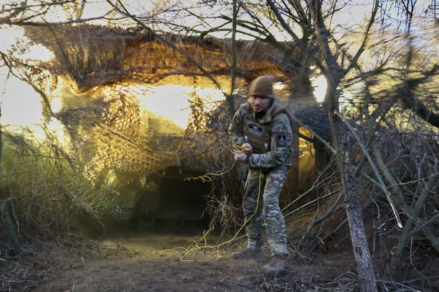 In this photo provided by Ukraine's 65th Mechanized Brigade press service, a soldier fires a 155mm M-109 "Paladin" howitzer towards Russian forces on the frontline in the Zaporizhzhia r ...