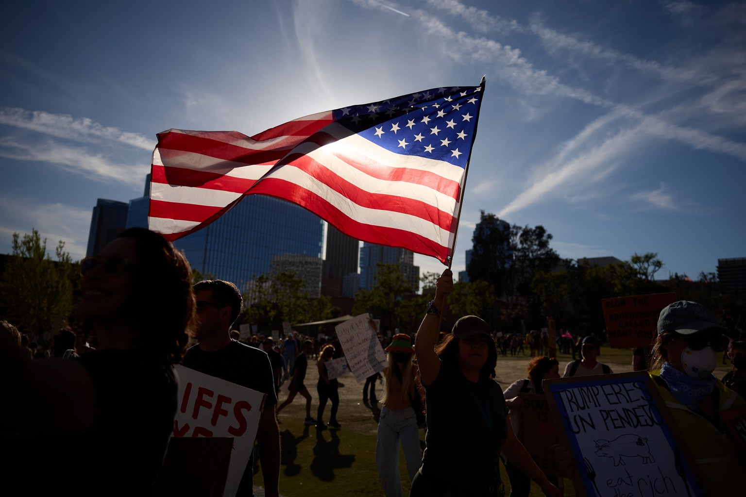 epa12012812 People march during a protest against President Trump and his policies in Los Angeles, California, USA, 05 April 2025. Protests took place across the country against the US president on 05 ...