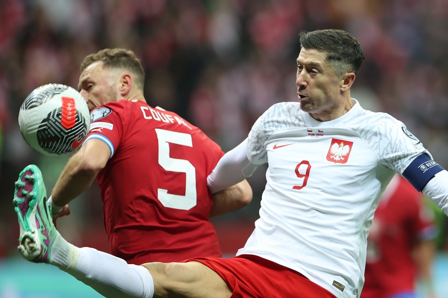 epa10981641 Robert Lewandowski (R) of Poland and Vladimir Coufal (L) of Czech Republic in action during the UEFA EURO 2024 qualifying soccer match between Poland and the Czech Republic in Warsaw, Pola ...