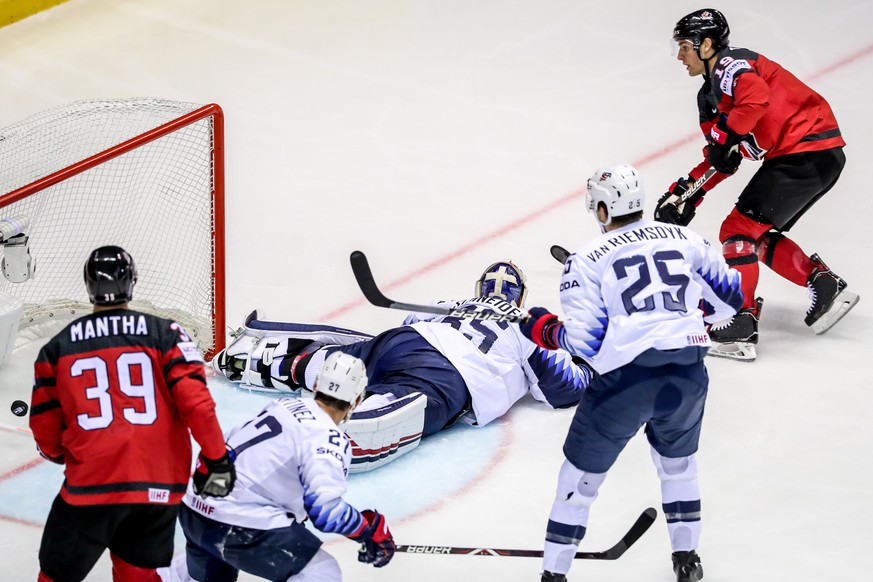 epa07590133 Kyle Turris of Canada (R) scores against goalkeeper Cory Schneider of US (C) during the IIHF World Championship group A ice hockey match between Canada and USA at the Steel Arena in Kosice ...