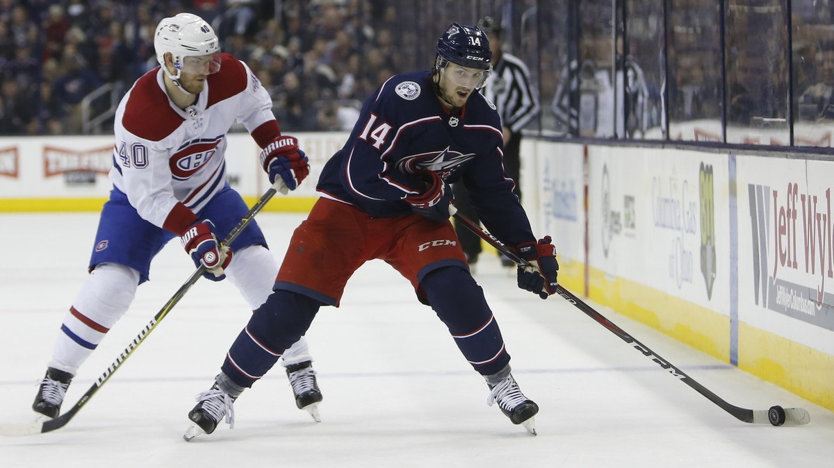 Columbus Blue Jackets' Dean Kukan, right, of Switzerland, looks for an open shot as Montreal Canadiens' Joel Armia, of Finland, defends during the second period of an NHL hockey game Thursda ...