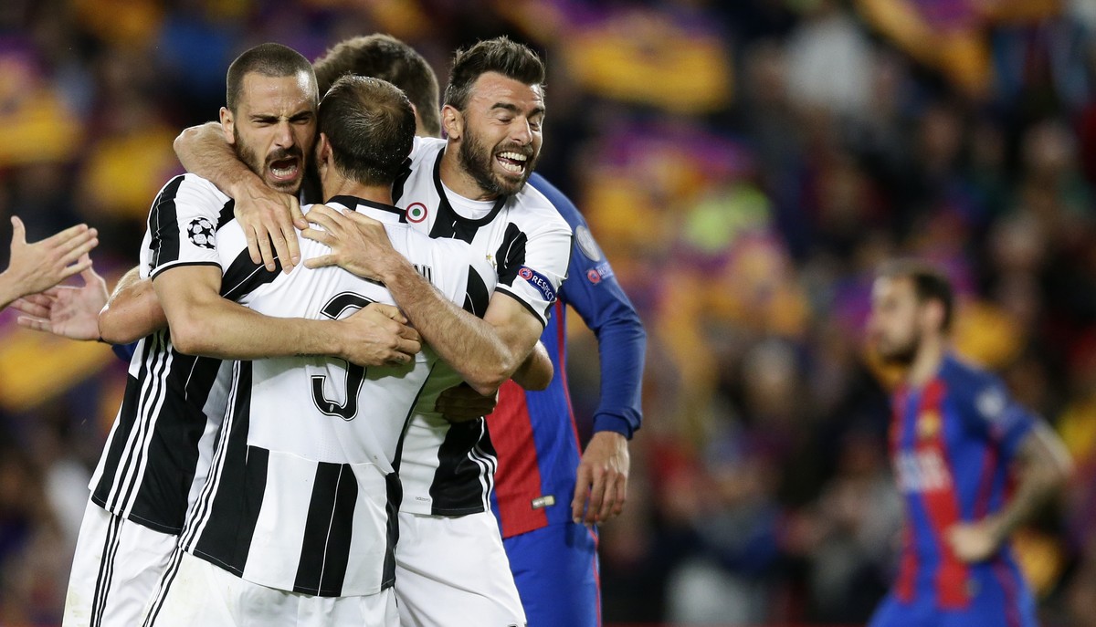 Juventus' Leonardo Bonucci, left, celebrates with teammates Giorgio Chiellini, center, and Andrea Barzagli during the Champions League quarterfinal second leg soccer match between Barcelona and J ...