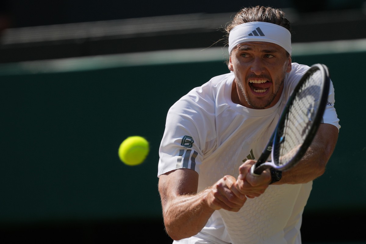Alexander Zverev of Germany returns the ball to Taylor Fritz of the United States in their quarter-final men's singles match at the Wimbledon Tennis Championships in London, Wednesday, July 8, 20 ...